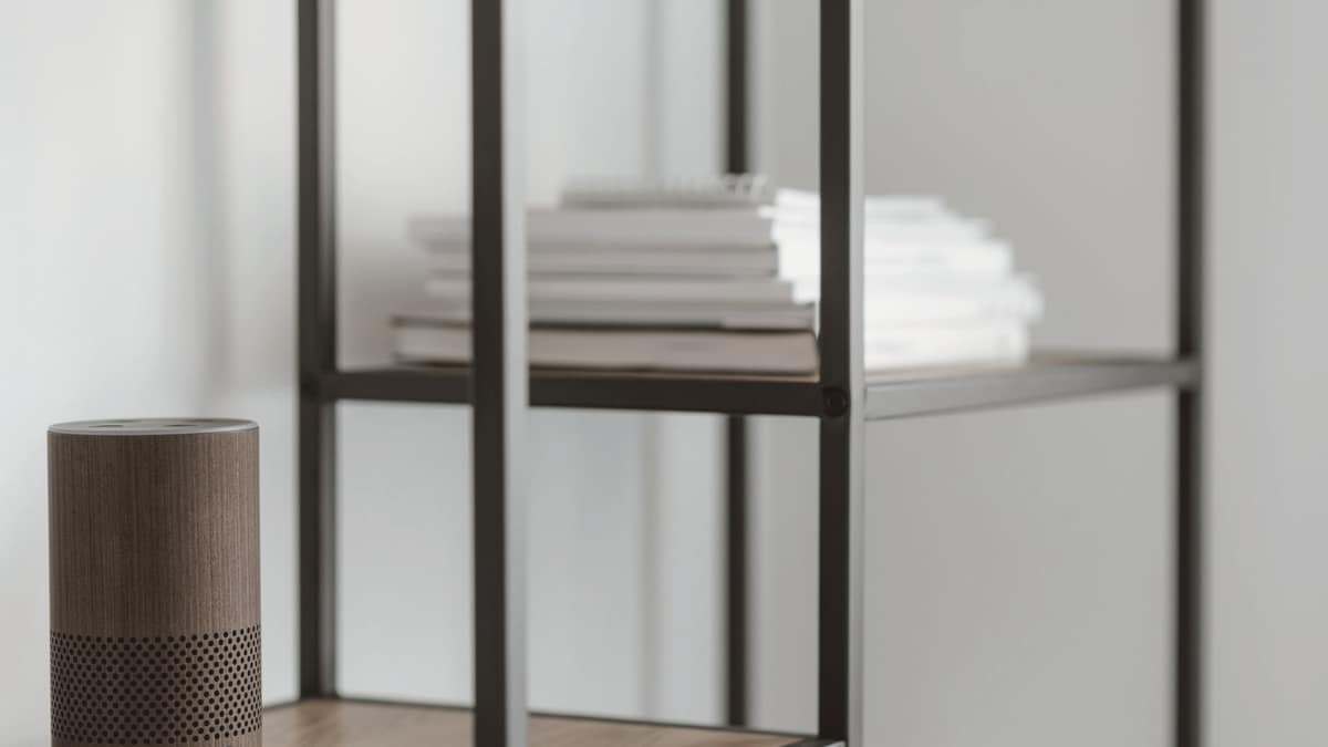 A smart speaker on a minimalist shelf