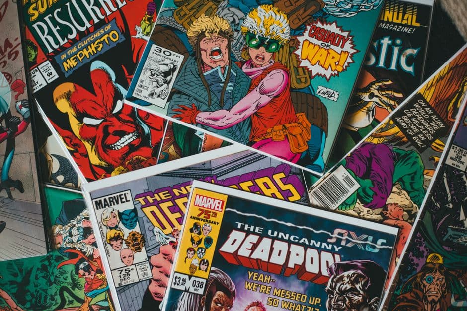 A pile of comic books with colourful covers, seen from above