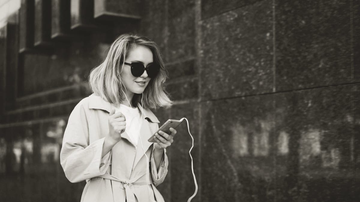 Headphones and a phone tucked into a coat pocket