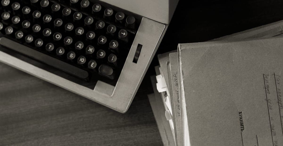 A typewriter with a sheet of paper on a desk