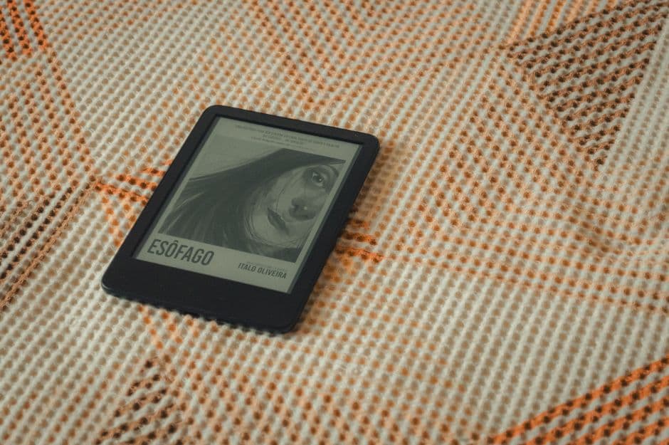 An e-reader resting on a textured blanket