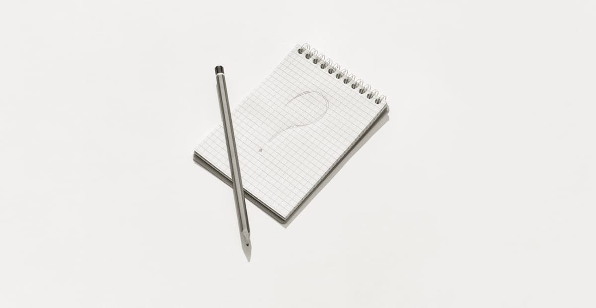 Question mark notes arranged on a desk