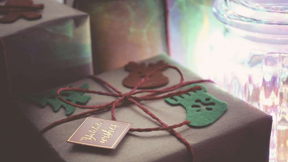 Wrapped presents with paper decorations under warm indoor lighting
