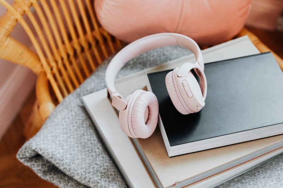 Wireless headphones resting on a stack of books