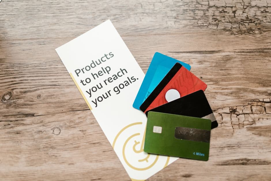 Several credit cards laid out on a wooden table